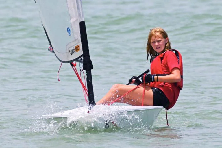 young girl in a small sail boat