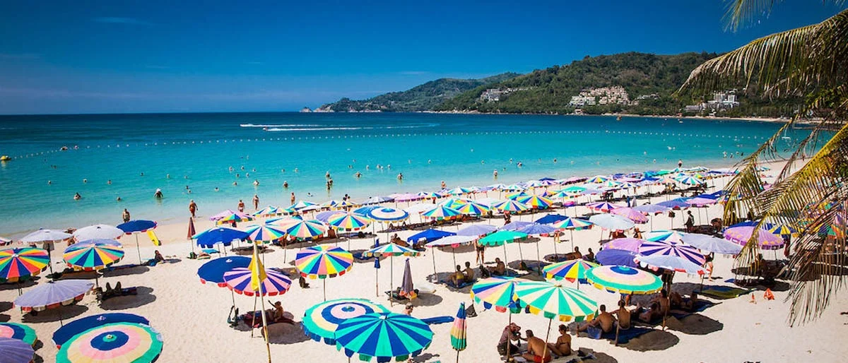 Patong Beach with rows of umbrellas and deck chairs