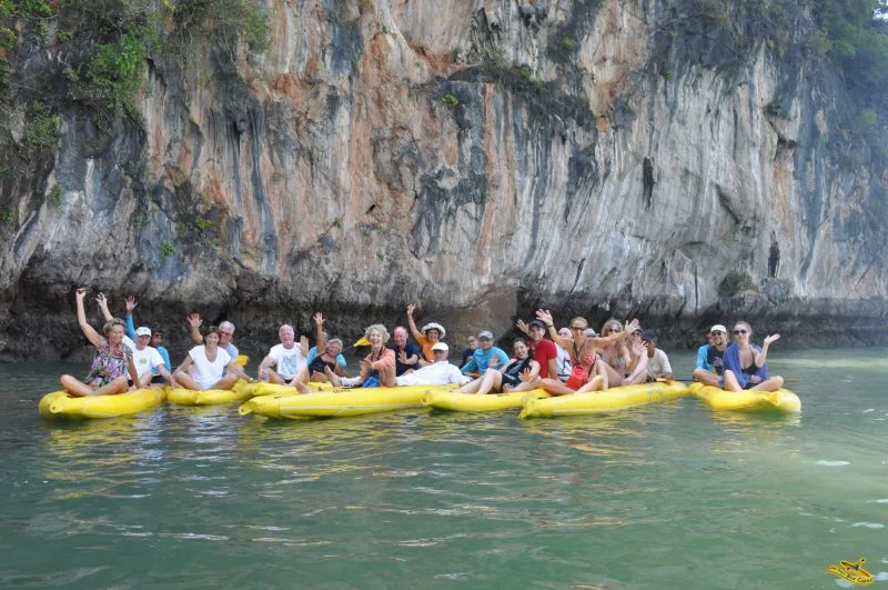 Group photo of people on a on sea kayaks