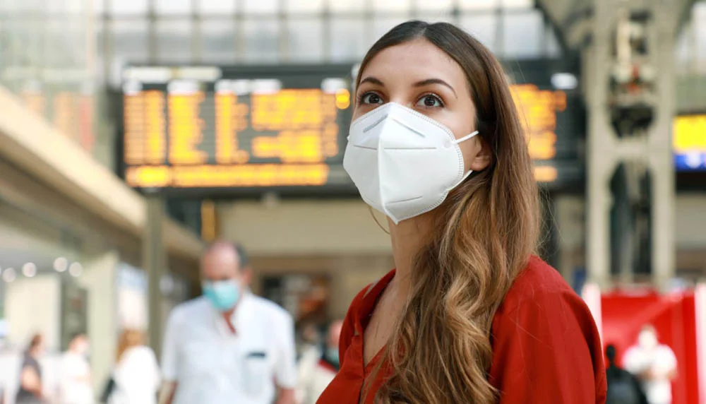 Traveller wearing a mask