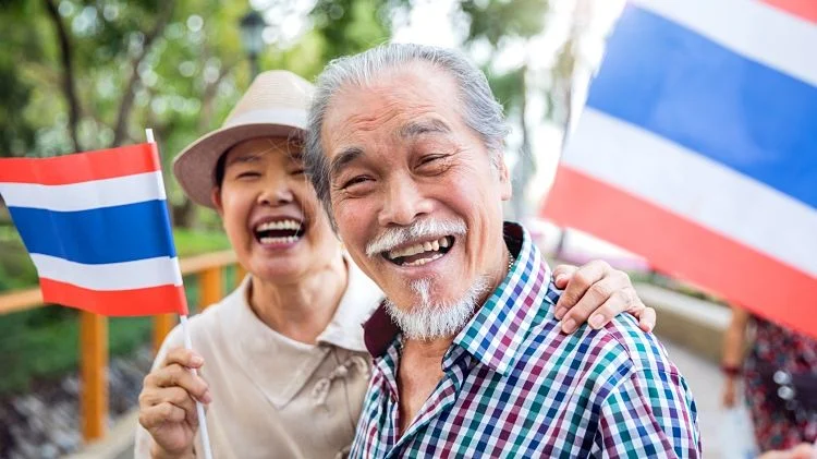 An older Thai couple smiling