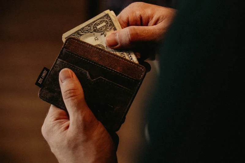 Man pulling bills out of a wallet