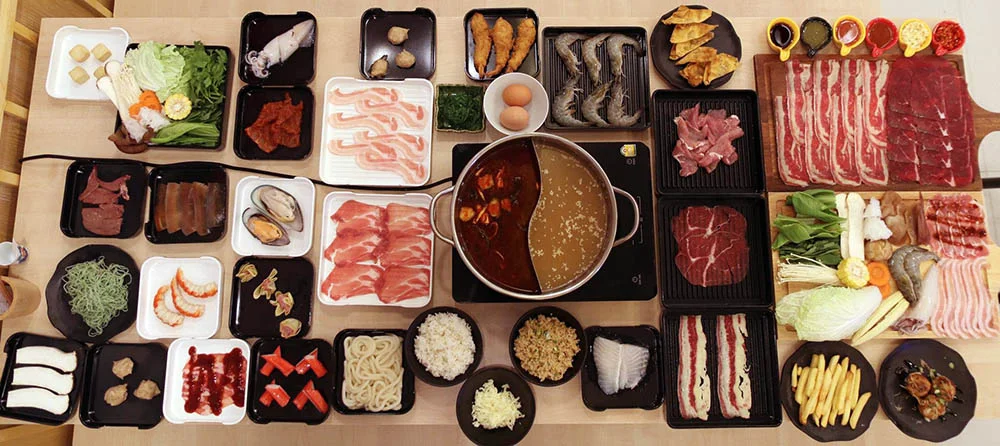 A shabu set with a selection of sliced beef cuts